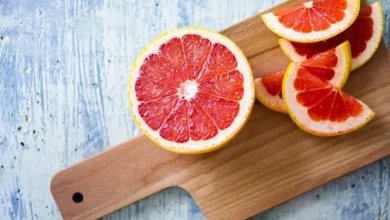 fresh grapefruit on chopping board