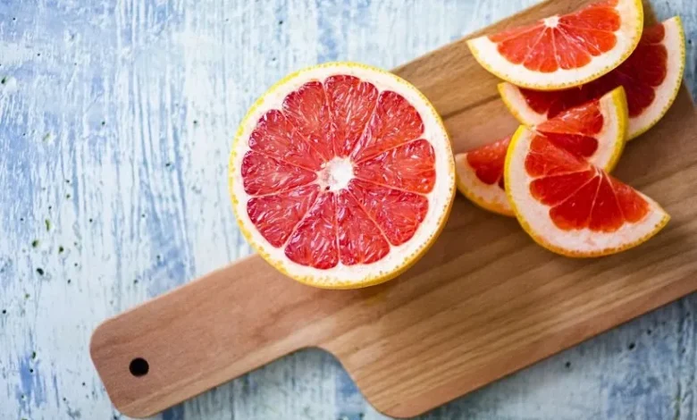 fresh grapefruit on chopping board